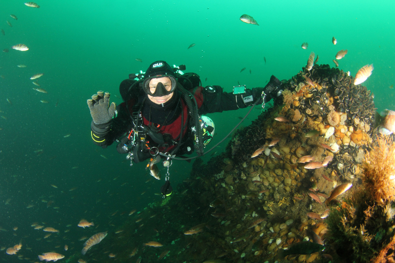 Scuba diver smiling without a regulator on the shipwreck of the RP Resore off the New Jersey coast